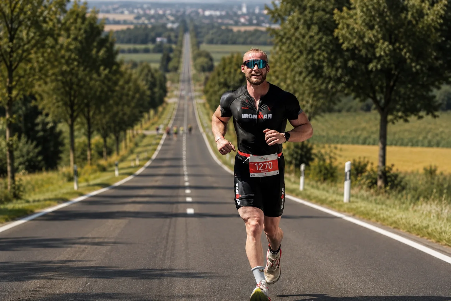Dominik Dörfl running on a dead straight country road during an Ironman race