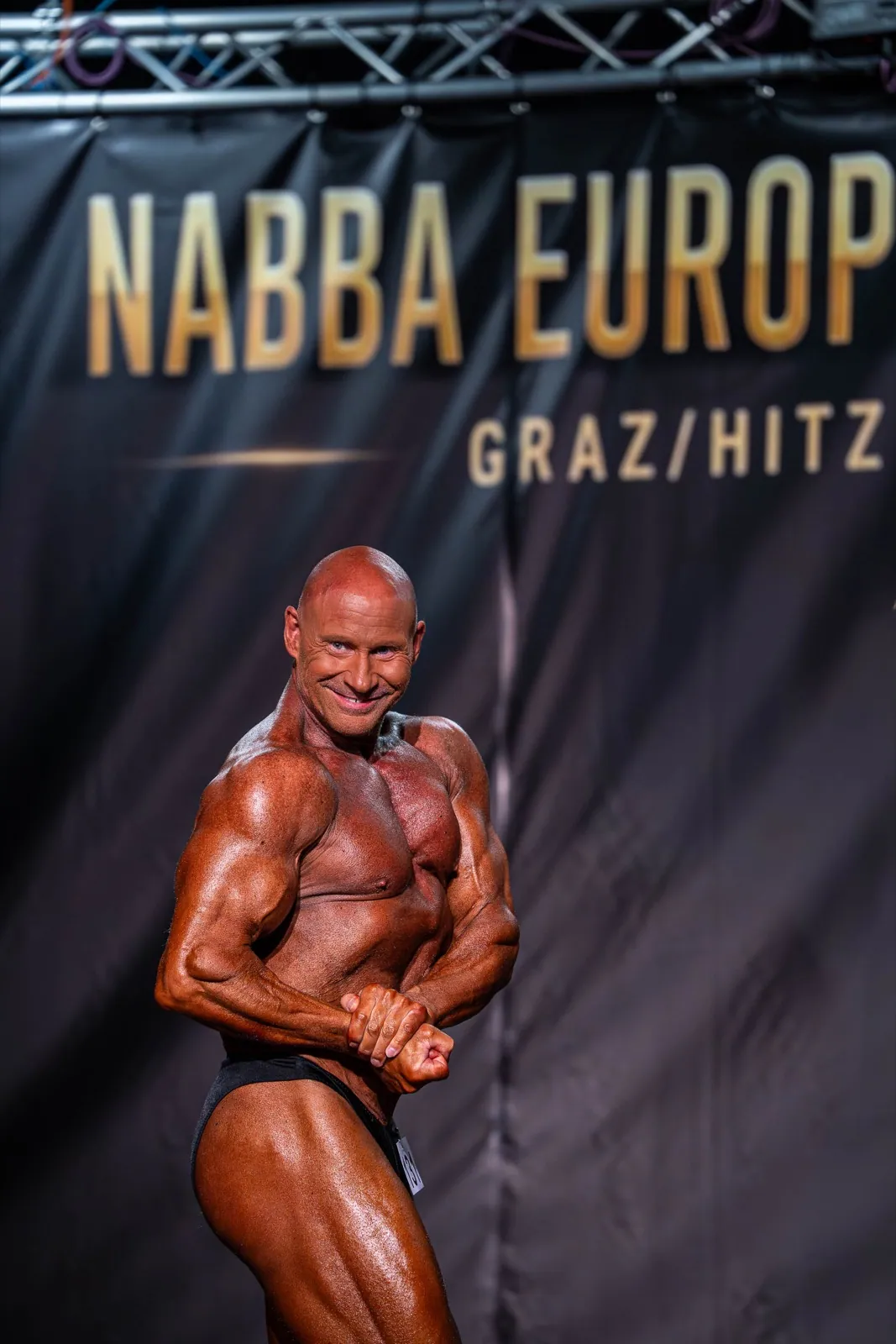 Günter Preis in contest condition on stage at the NABBA European Championship